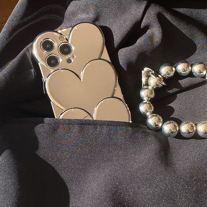 Funda Mirror Hearts – Edición Luxe con Asa de Perlas Metálicas